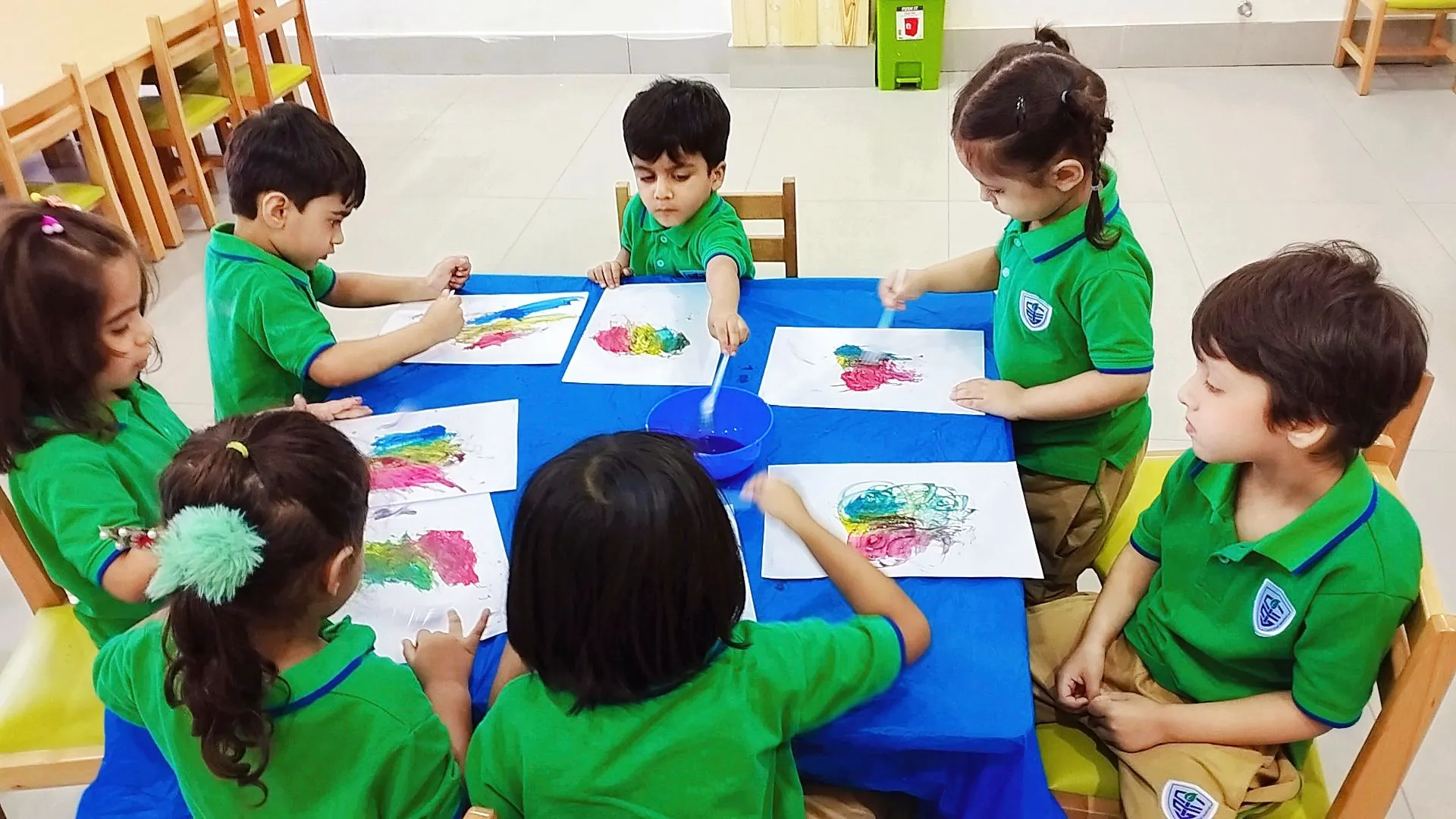 Young learners working together around a classroom table
